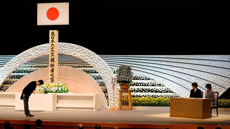 Japanese Prime Minister Shinzo Abe bows to Prince Akishino, second...