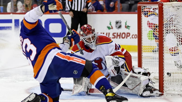 New York Islanders center Casey Cizikas scores a goal past...