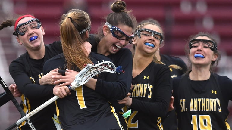 Kira Accettella of St. Anthony's gets congratulated by teammates Charlotte...