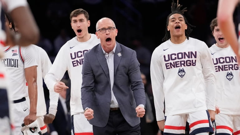 UConn coach Dan Hurley and players react during the first...