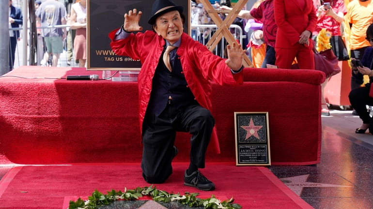 Actor James Hong poses after being honored with a star...