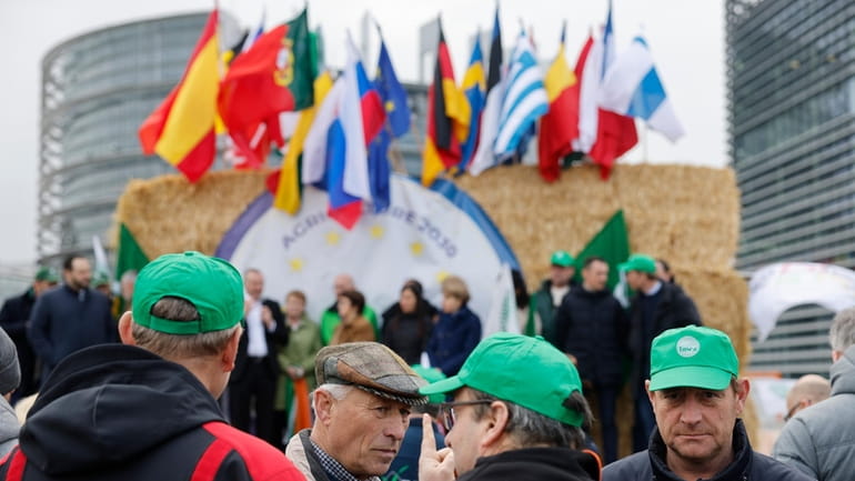 Farmers gather Tuesday, March 12, 2024 outside the European Parliament...