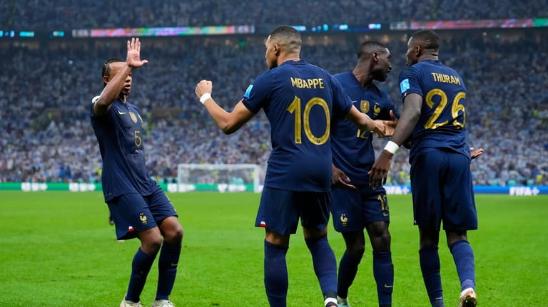 France's Kylian Mbappe celebrates with teammates scoring from the penalty...