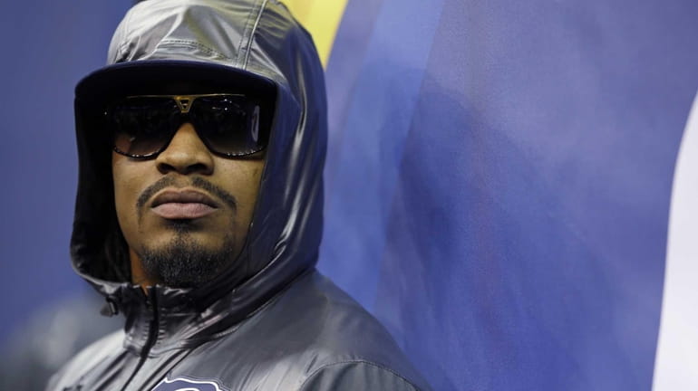 Seattle Seahawks' Marshawn Lynch stands against a wall during Media...