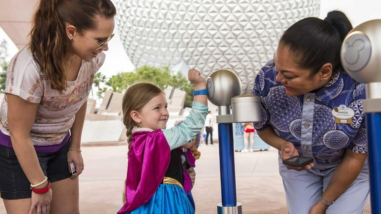 Walt Disney World Resort guests use MagicBands for park entry...