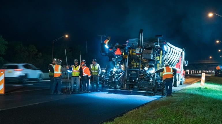 A crew works to repave on the Long Island Expressway...