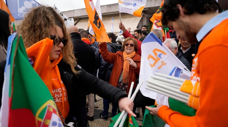 Flags are distributed to supporters of the center-right Democratic Alliance...