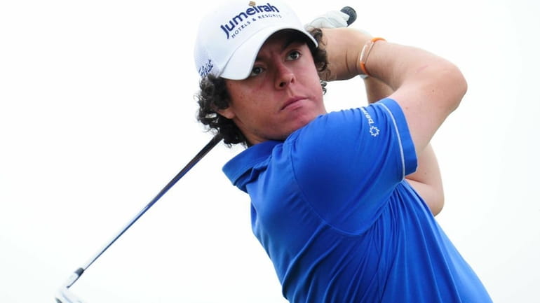 Rory McIlroy of Northern Ireland tees off on the 16th...
