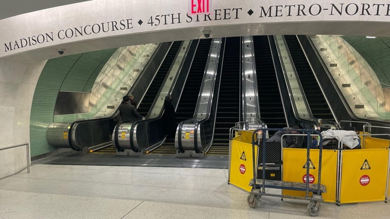 One of the five escalators that greet commuters exiting the...