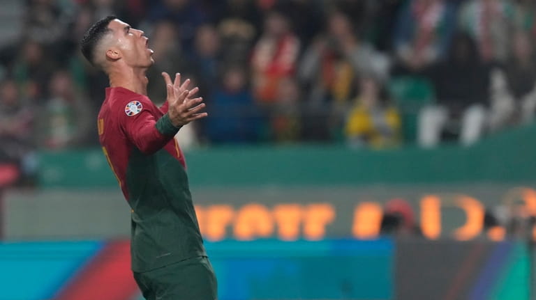 Portugal's Cristiano Ronaldo reacts after missing a chance to score...