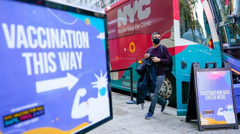 A man leaves a vaccination bus in Manhattan earlier this...