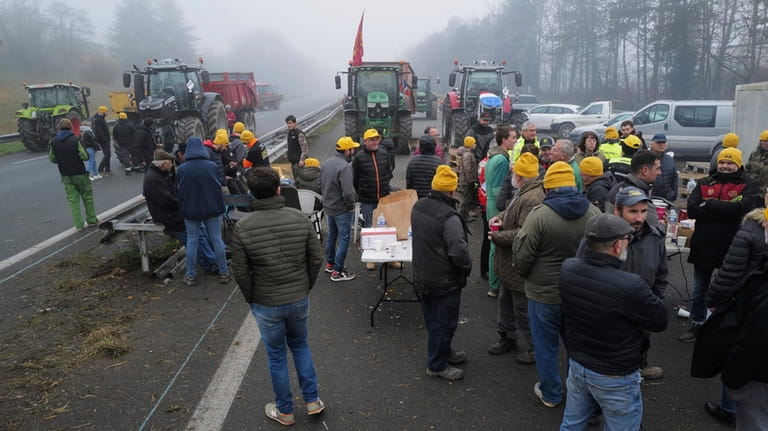 Farmers block a highway, near Agen, southwestern France, Saturday, Jan....