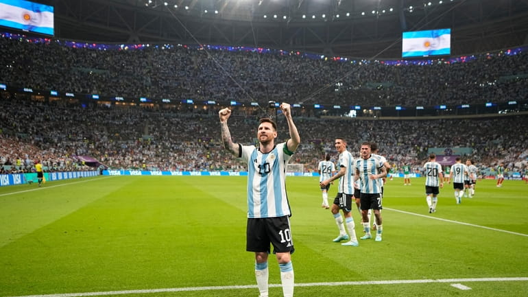 Argentina's Lionel Messi celebrates after scoring his side's opening goal...
