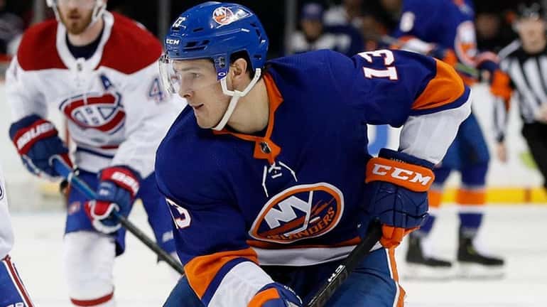 Mathew Barzal of the Islanders skates against Max Domi of the Canadiens...