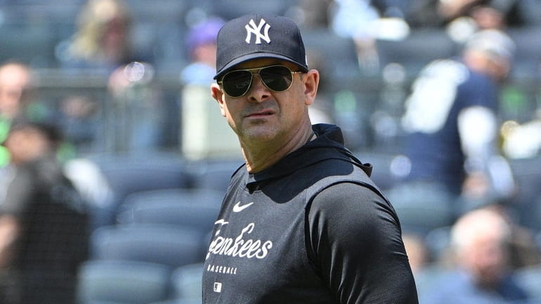 Yankees manager Aaron Boone walks to the dugout after a...