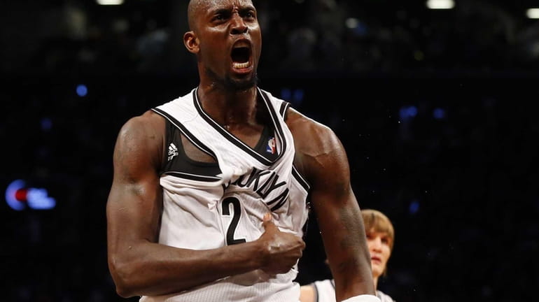 Kevin Garnett of the Nets reacts after winning a loose...