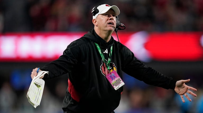 Louisville coach Jeff Brohm reacts after a play during the...