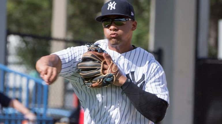 Yankees' Gleyber Torres throws to first against the Phillies during...
