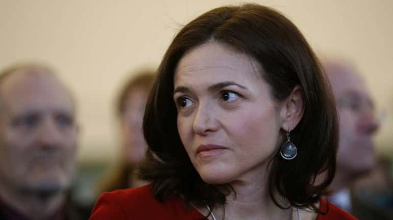 Sheryl Sandberg, chief operating officer of Facebook Inc., sits in...