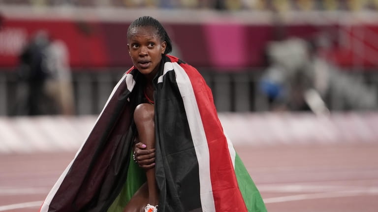 Faith Kipyegon, of Kenya celebrates after winning gold after the...