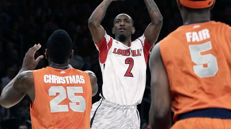 Louisville's Russ Smith shoots over Syracuse's Rakeem Christmas and C.J....