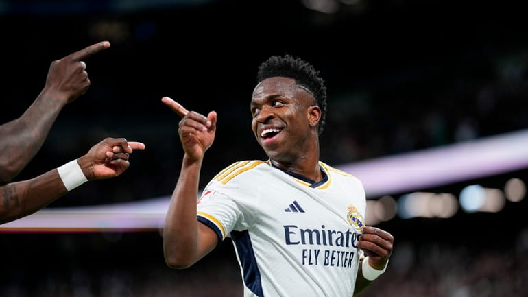 Real Madrid's Vinicius Junior celebrates after scoring his side's first...