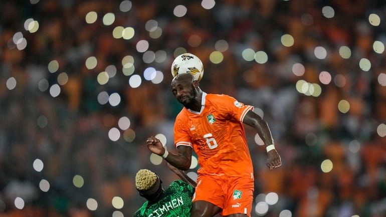 Ivory Coast 's Seko Fofana, top, duels for the ball...