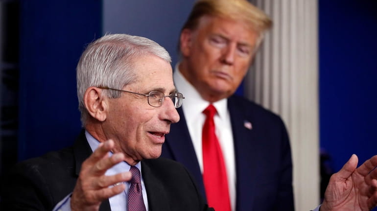 President Donald Trump watches as Dr. Anthony Fauci, director of...