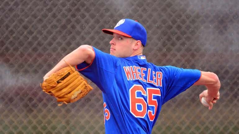 Mets pitcher Zack Wheeler delivers a pitch during a spring...
