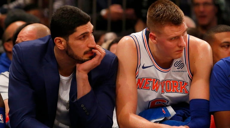 Enes Kanter of the New York Knicks look on from...