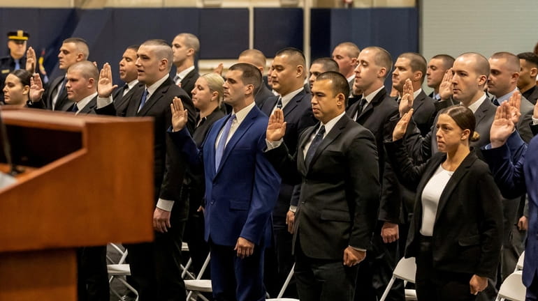 Fifty nine new Nassau County Police Department recruits are sworn...