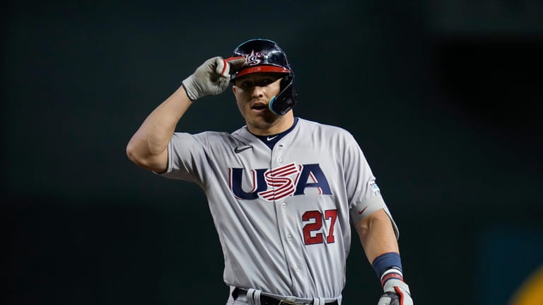 United States' Mike Trout reacts after hitting an RBI single...