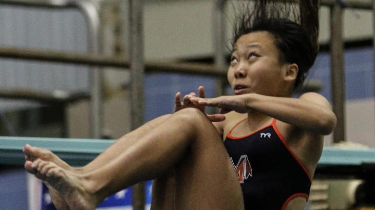 Victoria Wang of Manhasset midway through her reverse, one and...