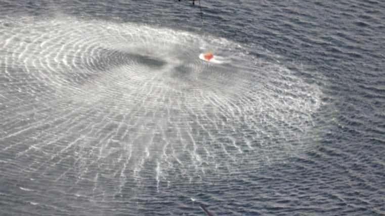 Japan's Self-Defense Forces's helicopters scoop water off Japan's northeast coast...