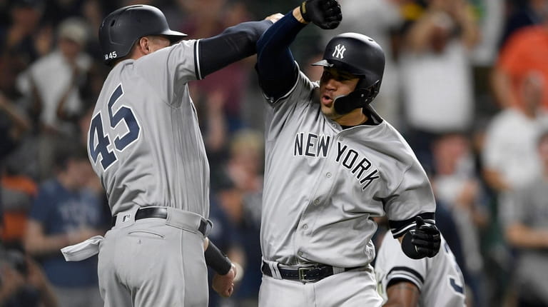 New York Yankees' Gary Sanchez, right, celebrates his three-run home...