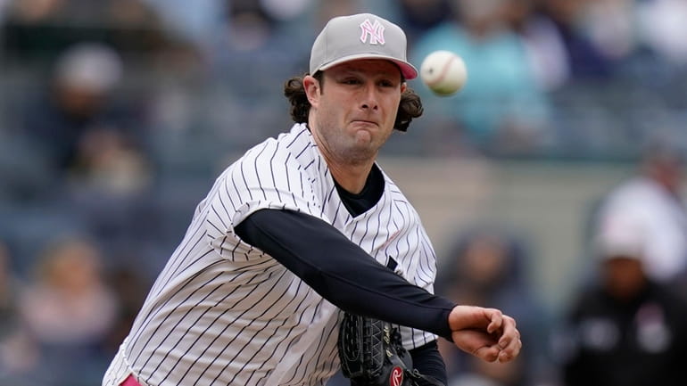 Yankees starting pitcher Gerrit Cole throws to first base during...