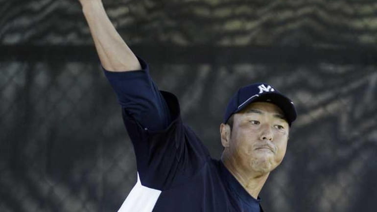 Yankees starting pitcher Hiroki Kuroda throws in the bullpen at...