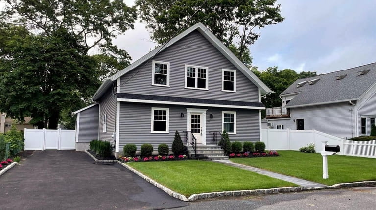 This renovated 4-bedroom, 2½-bath Colonial in East Islip has an open...