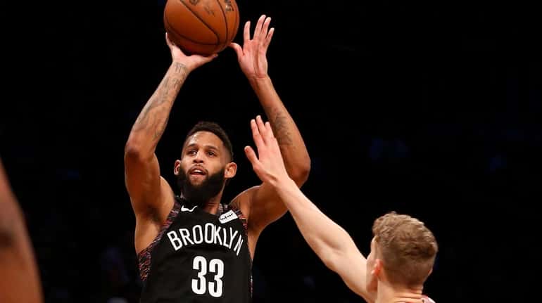 Allen Crabbe takes a three-point shot against the Chicago Bulls at...