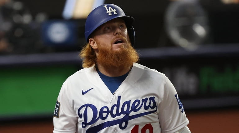 Justin Turner of the Dodgers reacts after striking out against...