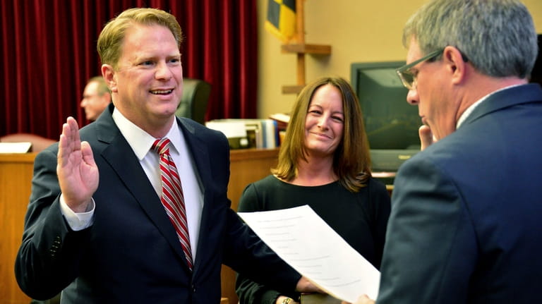 Washington County Circuit Court Clerk Kevin Tucker, right, swears in...