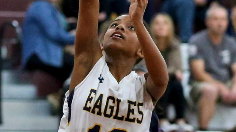 West Babylon guard Jade Dockery drives the baseline for two...