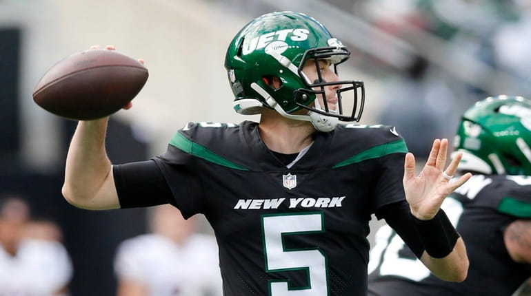 Mike White of the Jets throws a pass during the third...