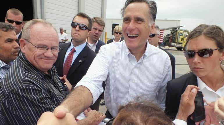 Republican presidential candidate, former Massachusetts Gov. Mitt Romney shakes hands...