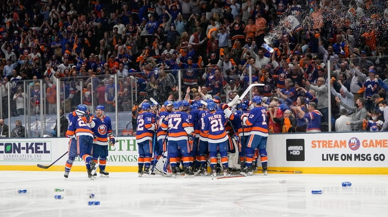Fans cheer as the Islanders celebrates after Game 6 of an...