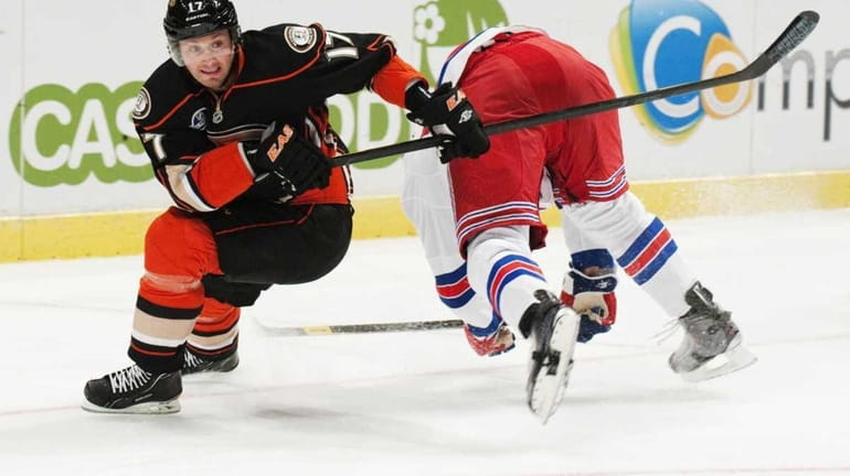 Rangers player Mike Rupp vies with Anaheim's Lubomir Visnovsky during...