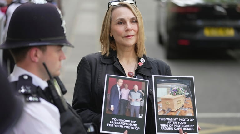 Lorelei King holds up pictures of her late husband Vincent...