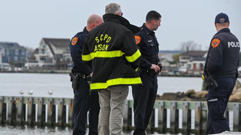 Suffolk police officers and arson investigators Sunday morning at Venetian Shores...
