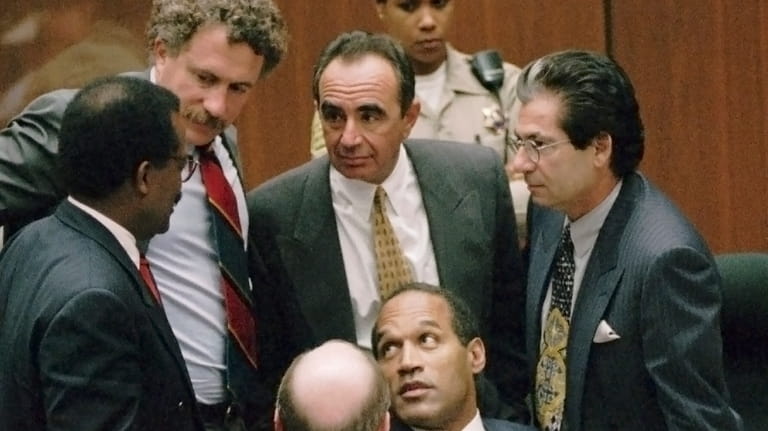 FILE- Defendant O.J. Simpson is surrounded by his defense attorneys,...