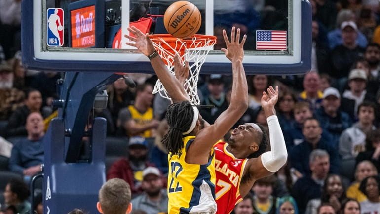 A shot by Indiana Pacers forward Isaiah Jackson, top left,...